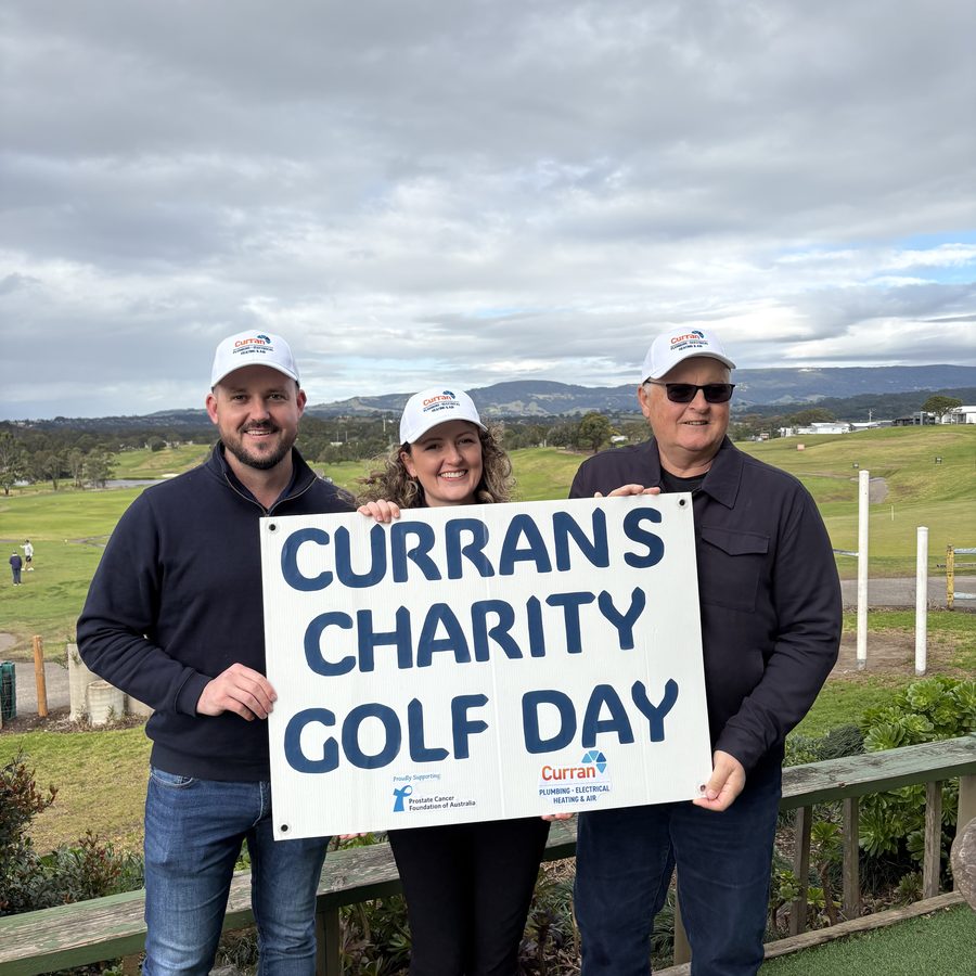 The Curran family holding their Charity Golf Day sign, supporting the Prostate Cancer Foundation of Australia